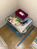 Stack showing scissors, sticker sheets, binder, clear and blue totes