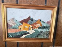 Front view of signed stone/marble inlay landscape in gold wood frame