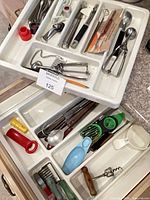 Both drawer inserts displaying full assortment of utensils and gadgets