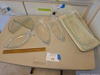 Group shot showing all six serving pieces on table with lot tag