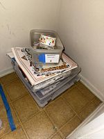 Lot overview showing papers, storage cases and tub