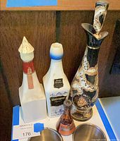Front view of all four decorative liquor bottles standing together