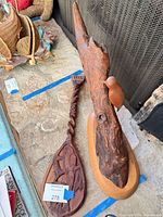 Driftwood bird sculpture and carved spoon side by side
