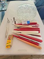 Group view of all items on table: candles, star holders, snuffer, Leigh trimmer box, cut glass bowl