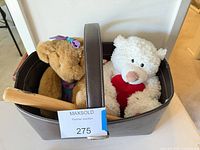 Basket containing two teddy bears and mini bat