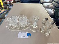 all six cut glass items arranged on table