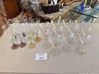 All 22 stemware pieces grouped: multi-color stem cordial glasses and etched coupe glasses