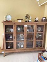Full front view of display cabinet showing glass and mesh doors and shelves