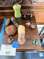 Group overview of all miniature sewing items on wood surface