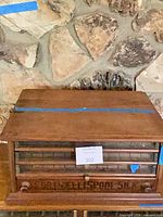 Front view showing glass drawers, stencilled base, overall form