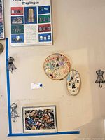 Overall view showing framed thimble print, two hoop artworks, wire hooks