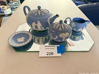 Full tea set arranged on mirror tray showing all pieces