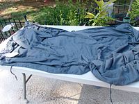 Full view of dark gray weighted blanket spread on table