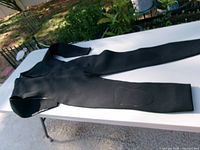 Full view of wetsuit laid flat showing overall condition and design