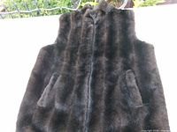 Front view of black faux mink vest showing pockets and overall condition