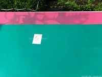 Turquoise and pink yoga mats side by side