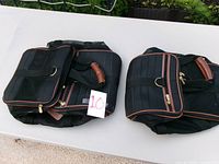 Both Sherpa carriers folded flat on table, showing size difference