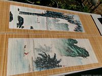 Two large ink landscape scrolls laid side by side