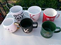 Group of six upright mugs showing exterior designs