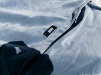 DKNY tag on light blue-grey fabric