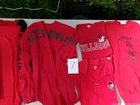 All five University of Georgia tops displayed on table