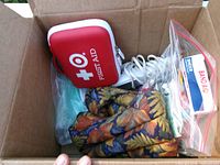 Items inside carton: first aid kit, massager, heat wrap, masks