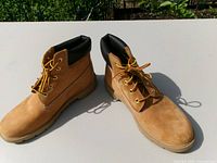 Oblique view of both boots showing uppers, laces, collars