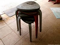 Five triangular wooden plant stands stacked