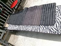 Pad laid flat zebra side up on chaise lounge frame