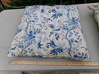 Single pillow close-up showing pattern and cord edge next to 24" ruler for scale