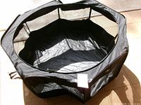 Top view of open black foldable pet playpen
