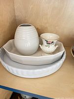All four items stacked: flan dish, serving dish, Innovation vase, Wedgwood vase