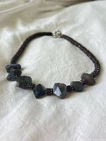 Full view of necklace showing bead arrangement and clasp