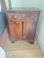 Front view showing full cabinet with drawer and doors closed