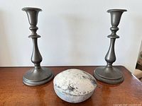 Pair of pewter candlesticks and lidded container on table