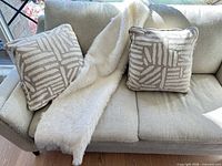 Cushions and throw displayed on sofa