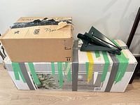 Tree boxes and folded metal stand atop