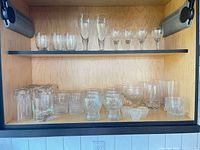 Full cabinet view showing all glassware on two shelves