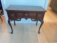 Full frontal view of lowboy showing overall form, drawers, legs