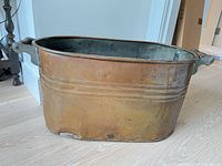 Full view of oval copper basin front and side