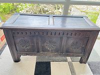 front view showing three carved panels and top