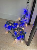string lights plugged in and illuminated blue and warm white