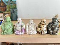 Front view of all five Buddha figurines lined up