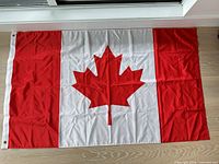 Full view of Canadian flag laid flat showing design and dimension