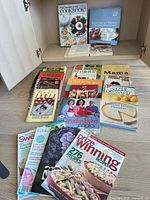 Group shot of cookbooks and magazines inside cabinet