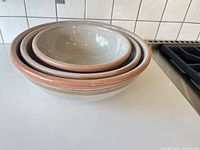 Three nested Deprettis Linea Tre bowls showing interior glaze and terracotta rim