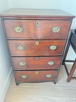 Full front view of mahogany chest showing four drawers and overall condition