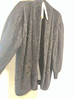 Cardigan front view showing open style and bead embellishments