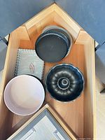 Drawer view showing bundt pan, pink springform, rectangular tart pan and round tart pan