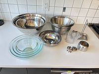 Group shot of all mixing bowls and measuring cups on countertop